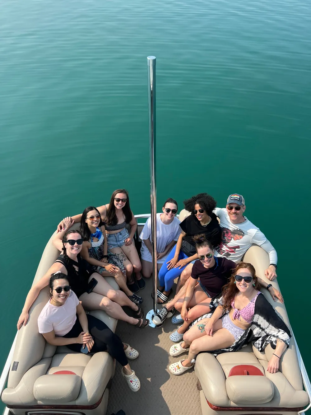 A large group seated around the boat's lounge
