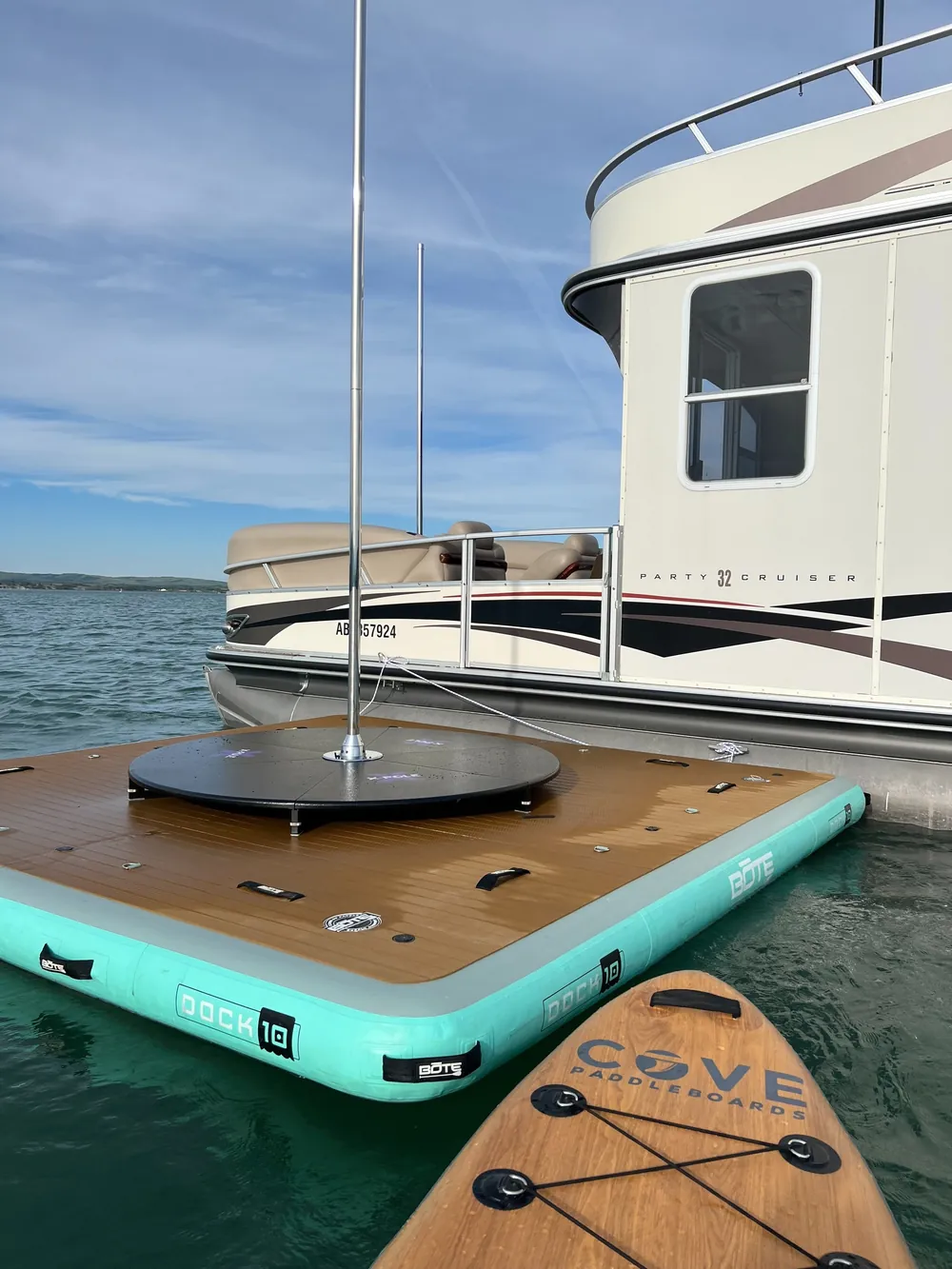 The floating dock with its own pole, moored alongside the boat